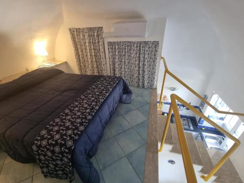 a bedroom with a bed in a room with a staircase at Maridea - Sottovento in Ponza