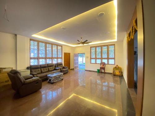 a living room with a couch and a ceiling fan at Dlr Tranquilla in Hyderabad