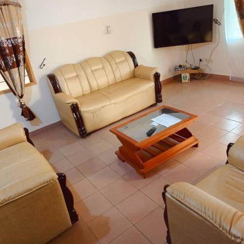a living room with a couch and a coffee table at Villa meublée Arconville 2 Chambre in Abomey-Calavi