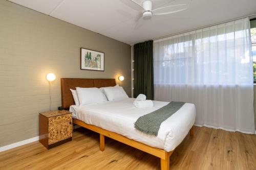 a bedroom with a large bed with a ceiling fan at Stylish apt facing the historic Telopea Park - Hosted by CanStay in Kingston 