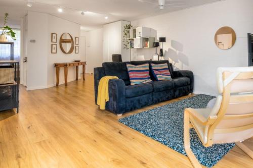 a living room with a couch and a table at Stylish apt facing the historic Telopea Park - Hosted by CanStay in Kingston 