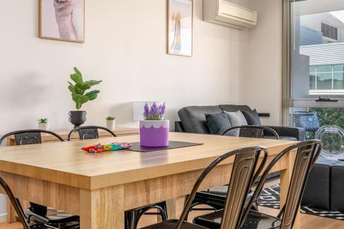 a dining room with a wooden table and chairs at Charming Apt 1min to Marketplace Gungahlin - Hosted by CanStay in Harrison