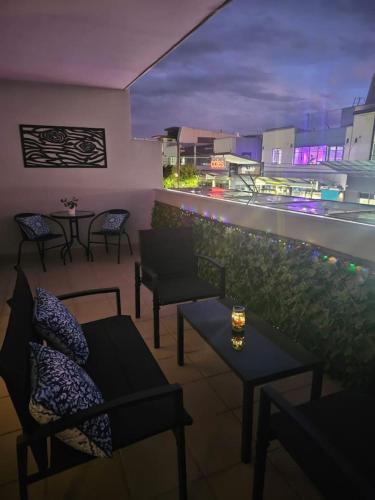 a rooftop patio with tables and chairs and a view at Charming Apt 1min to Marketplace Gungahlin - Hosted by CanStay in Harrison