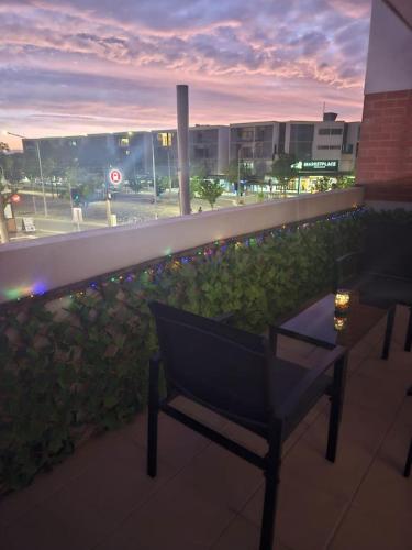 a bench on a balcony with a view of a street at Charming Apt 1min to Marketplace Gungahlin - Hosted by CanStay in Harrison