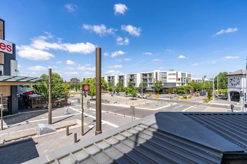 an empty street in a city with buildings at Charming Apt 1min to Marketplace Gungahlin - Hosted by CanStay in Harrison
