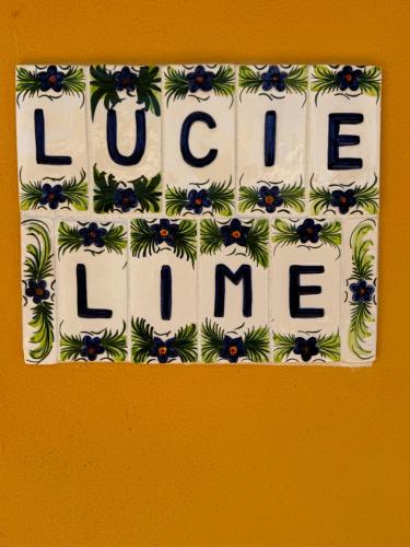 a sign with the words love love me on a wall at Lucie Lime GuestHouse in Luz