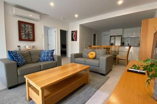 a living room with a couch and a table at 2BR Light Filled and Cosy Apartment - Hosted by CanStay in Phillip
