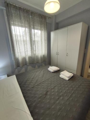a bedroom with a bed and a large window at Little Star in Ofrínion