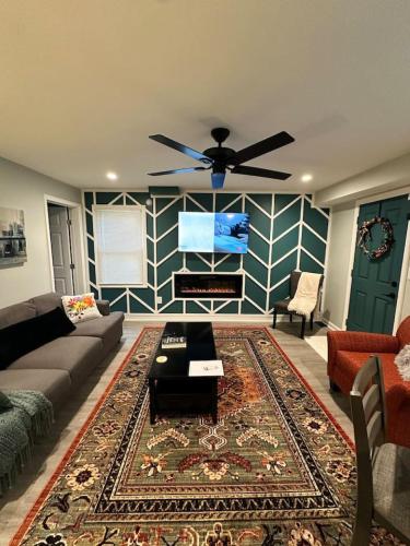 a living room with a couch and a flat screen tv at Sardis Forest Gem, 2BR, Fast WiFi, Free Parking in Charlotte