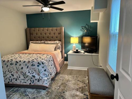 a bedroom with a bed and a flat screen tv at Sardis Forest Gem, 2BR, Fast WiFi, Free Parking in Charlotte