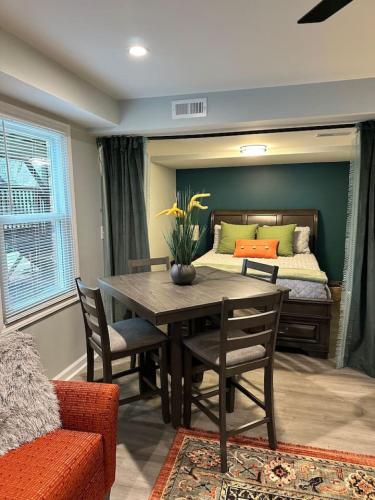 a dining room with a table and a bed at Sardis Forest Gem, 2BR, Fast WiFi, Free Parking in Charlotte