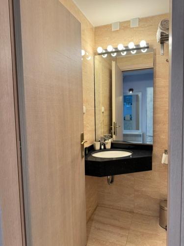 a bathroom with a sink and a mirror at PARALIA Souli di mare in Parga