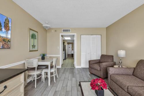a living room with a couch and a table at Oceanfront Condo Camelot By the Sea in Myrtle Beach