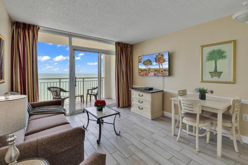 a living room with a couch and a table at Oceanfront Condo Camelot By the Sea in Myrtle Beach