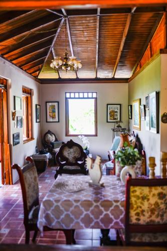 a living room with a table with a vase on it at Casa de Campo Vista Hermosa in Lares
