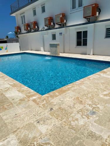 a swimming pool in front of a house at Sea Breeze Tunnel Hideaway 7 in Quebradillas