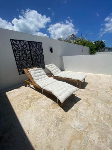 a group of white couches sitting on a patio at Sea Breeze Tunnel Hideaway 7 in Quebradillas