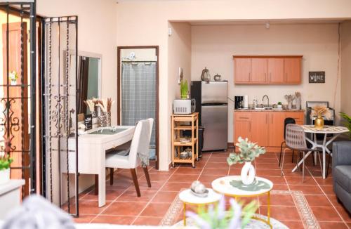 a kitchen and a living room with a table at Casa de Campo Vista Hermosa in Lares