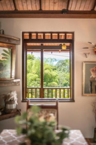 a window in a room with a table and a view at Casa de Campo Vista Hermosa in Lares