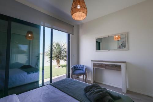 a bedroom with a bed and a fireplace and a mirror at OurMadeira - Vila Diana in Porto Santo