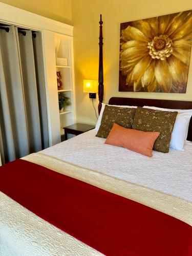 a bedroom with a large bed with a large flower painting on the wall at Bayberry Inn B&B and Oregon Wellness Retreat in Ashland