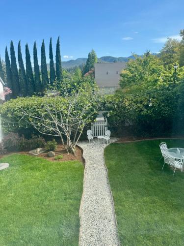 a garden with a bench in the grass at Bayberry Inn B&B and Oregon Wellness Retreat in Ashland