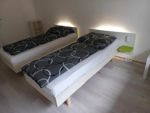 dos camas sentadas una al lado de la otra en una habitación en hoteliving Apartments Gießen-Süd, en Giessen