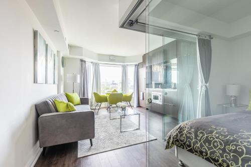 a bedroom with a bed and a table and chairs at Charming Downtown Condos by GLOBALSTAY in Toronto