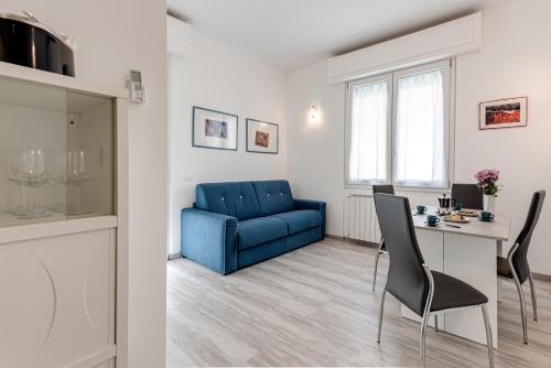 ein Wohnzimmer mit einem blauen Sofa und einem Tisch in der Unterkunft Frullhouse - Sweet Dreams in Florence in Florenz