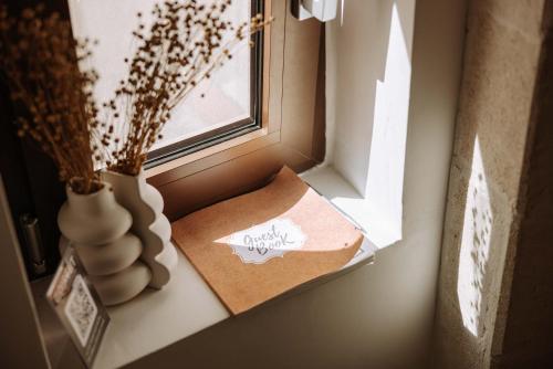 a window with a box and a vase on a window sill at Dirium - exclusive rooms in Monopoli