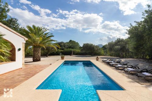 a swimming pool with lounge chairs next to a house at Villa Fantaxat by Abahana Villas in Benissa