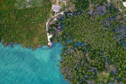 an aerial view of the ocean and a beach at Mkoko Villa in Fumba