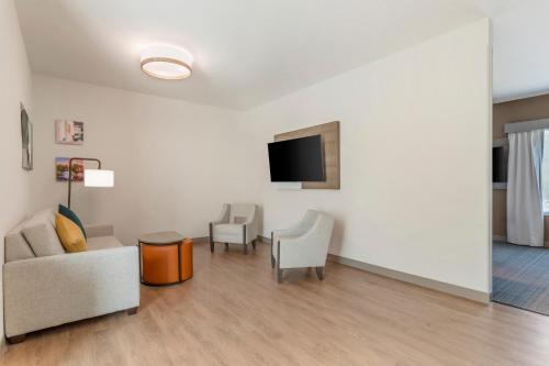 a living room with a couch and chairs and a tv at Comfort Suites Gatlinburg Downtown-Convention Center in Gatlinburg