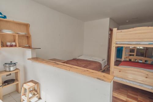 a small room with a bunk bed in it at Backpackers-balcones-river-lodge in Baños