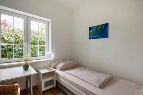 a room with a bed and a desk and a window at Comfortable room in central location in Hamburg