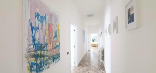 a hallway with paintings on the walls at Angela's Apartment. Elegant two bedroom house in Irsina in Irsina