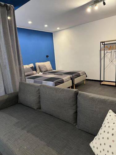 a room with two beds and a couch at Black Room & Breakfast in Bari