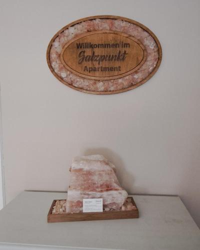 a sign on a wall above a rock on a shelf at Salzpunkt in Sankt Peter am Bichl