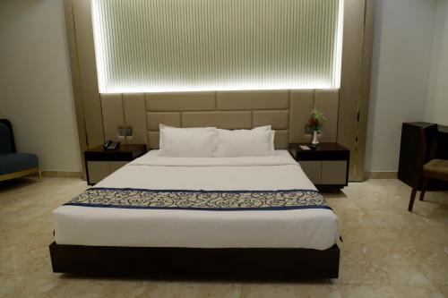 a bedroom with a large bed and a window at D'more Kuakata Hotel & Resort in Kuākāta