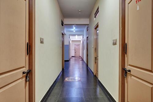 a corridor of an office building with a long hallway at OYO Flagship Jashwanth Residency in Mysore
