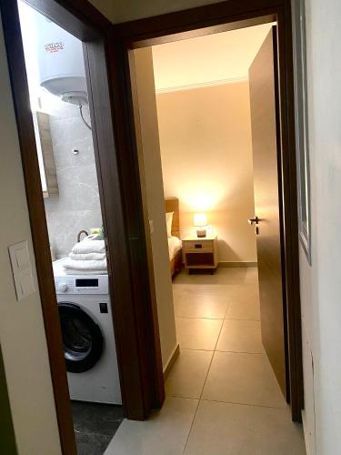 a hallway with a washing machine in a room at lividio apartment in Lefkada