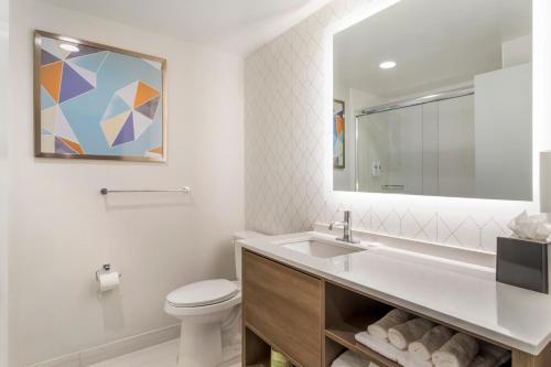 a bathroom with a sink and a toilet and a mirror at Comfort Suites Gatlinburg Downtown-Convention Center in Gatlinburg
