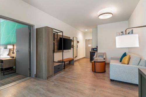 a large living room with a couch and a bed at Comfort Suites Gatlinburg Downtown-Convention Center in Gatlinburg