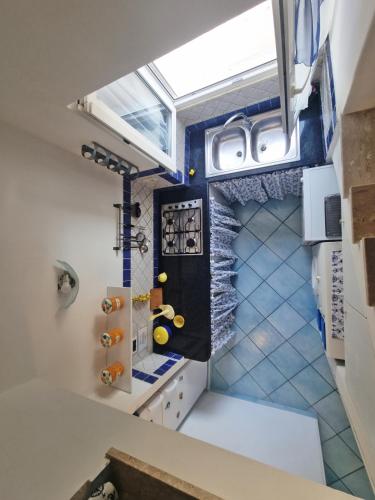 a small kitchen with a skylight in the ceiling at Maridea - Sottovento in Ponza