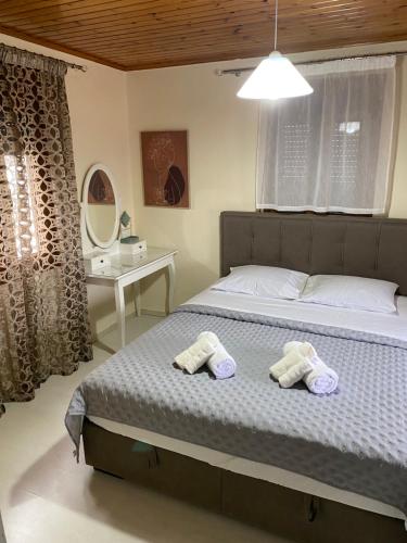 a bedroom with a bed with two towels on it at Ambelos Skala in Mytilini