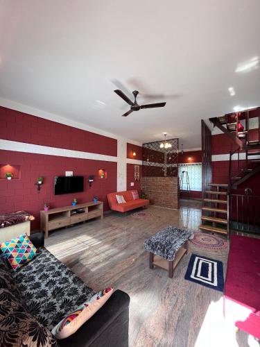 a large living room with a couch and a tv at Nandi Earth in Nandi