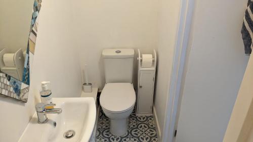 a small bathroom with a toilet and a sink at Comfort and Convenience double with ensuite London W7 in London