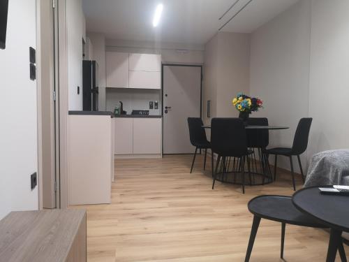 een woonkamer en een keuken met een tafel en stoelen bij Athenian Apartments, Syntagma square #6 in Athene