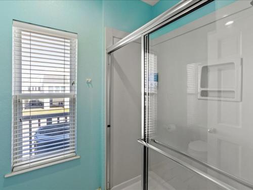 a bathroom with a shower and a glass shower stall at Beach Therapy -Baby Furniture *Arcade Game *Coffee in Galveston