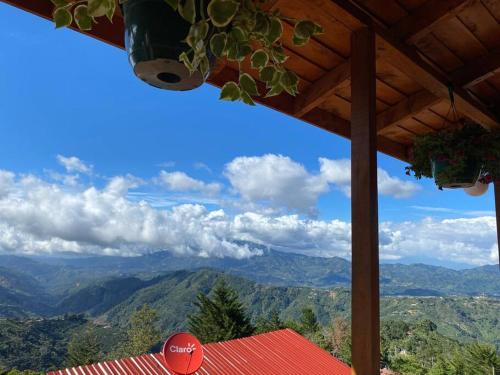 a view of the mountains from a roof of a house at Cabaña Peacock – CUTE cabin with an AMAZING view! in San Pablo